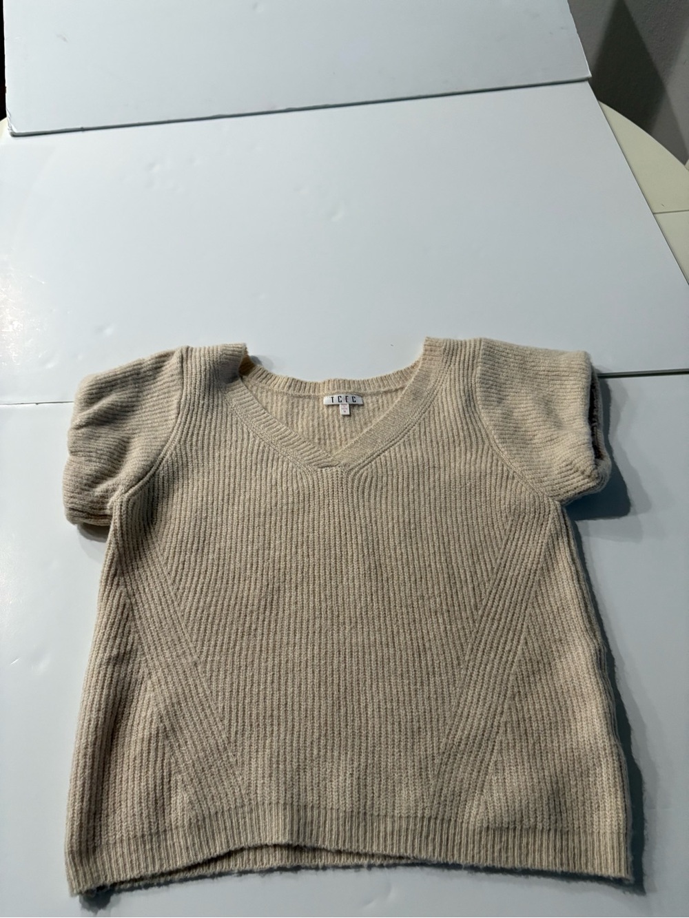 TCEC Beige V-Neck Short Sleeve Sweater with lined sleeves to give them emphasis.